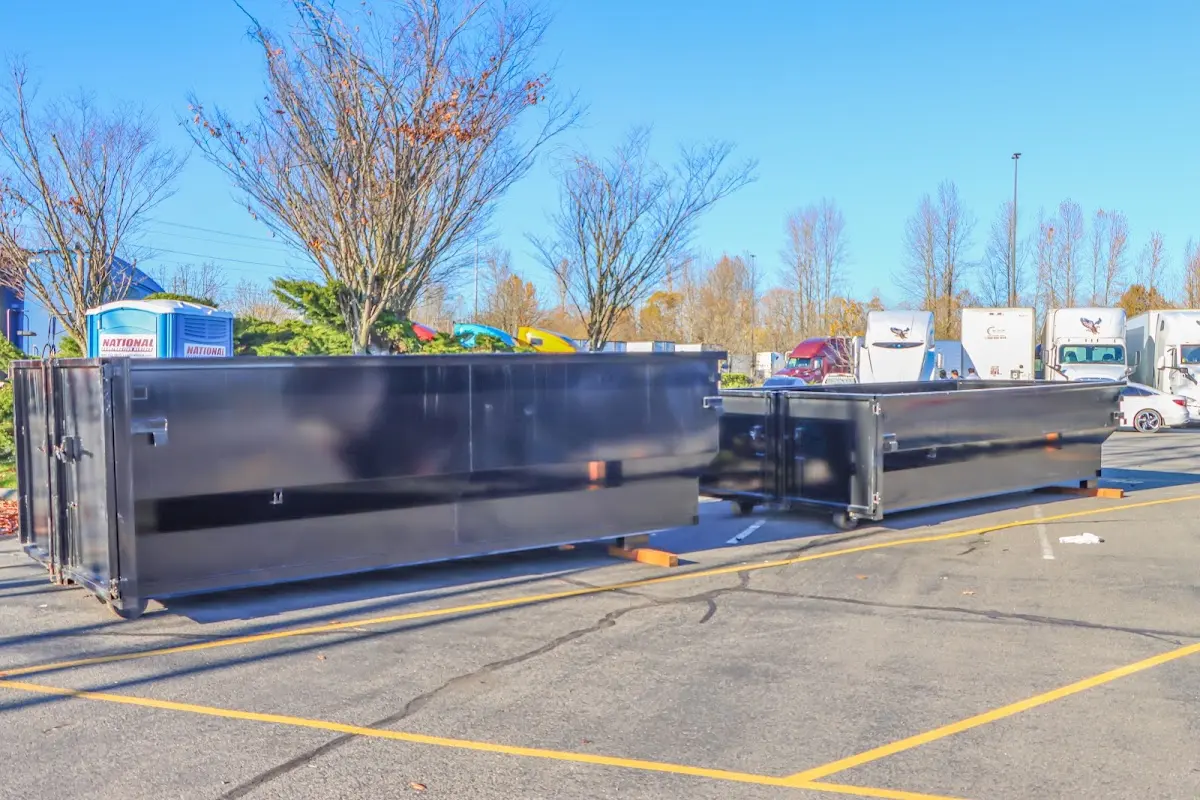 Professional dumpster rental service with roll-off container on residential driveway in Wetumpka